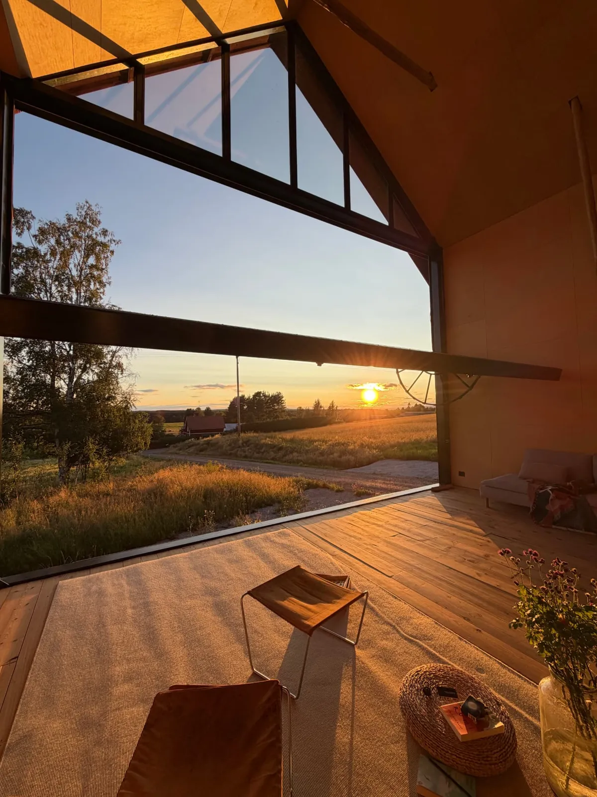 The eight-metre living-room window opened wide to a Dalarna sunset