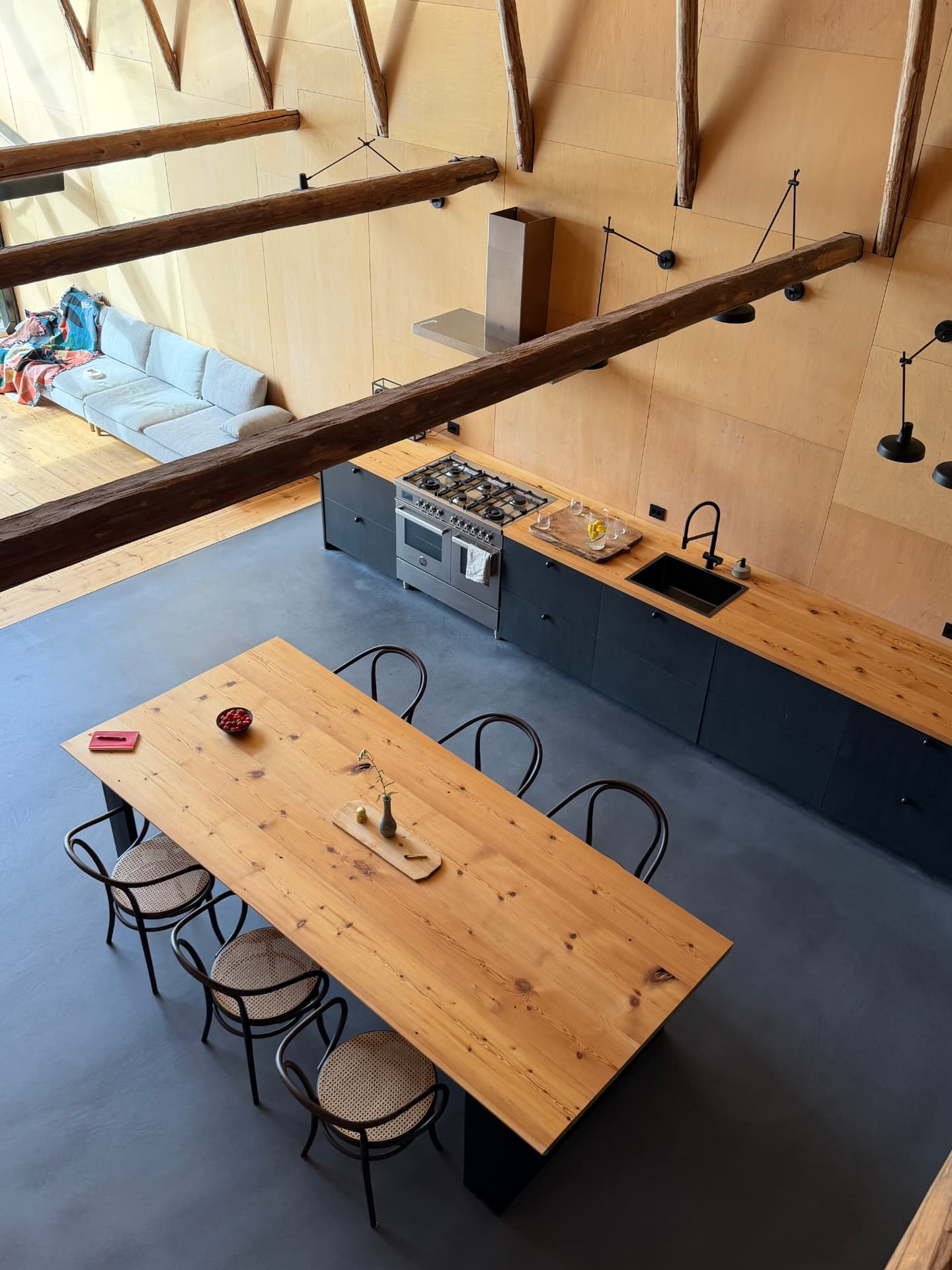The open-plan loft with long pine table and open kitchen